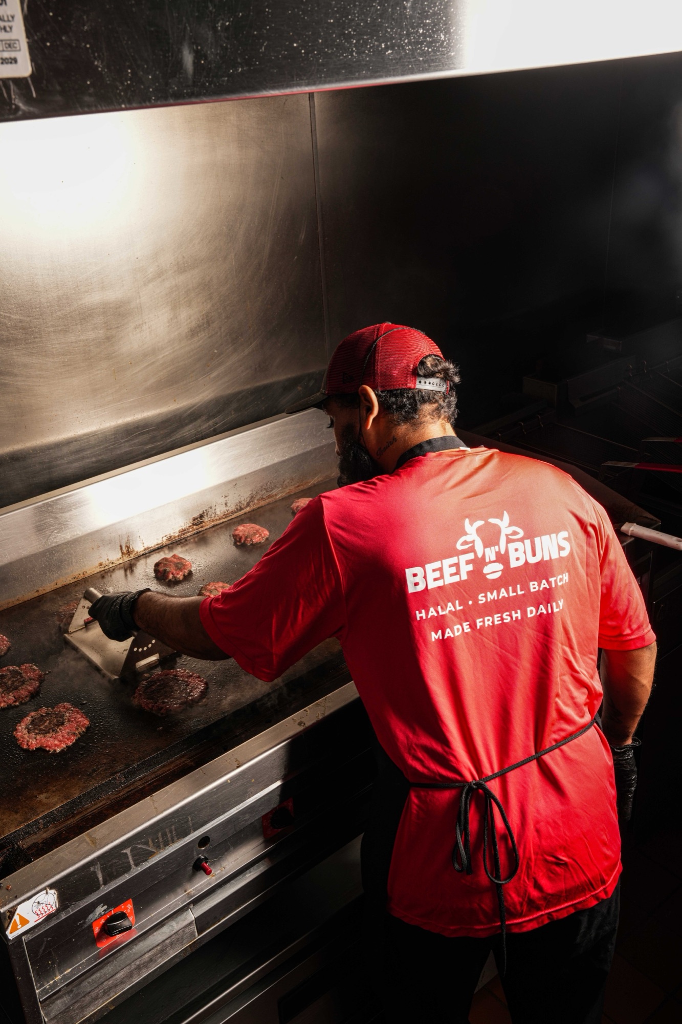 Smashing patties on the flat top at Beef N' Buns